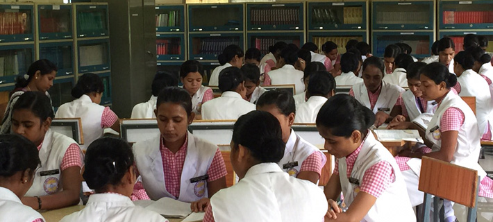 Nursing students studying in the college library